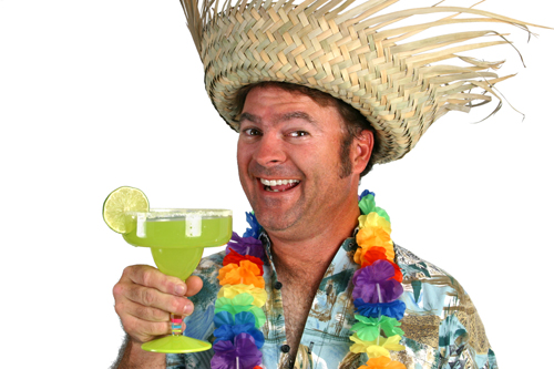 A man in a Hawaiian shirt, lei, and straw hat holding a margarita and looking really happy.