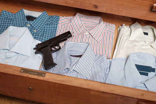 Gun hidden in a drawer full of shirt at home