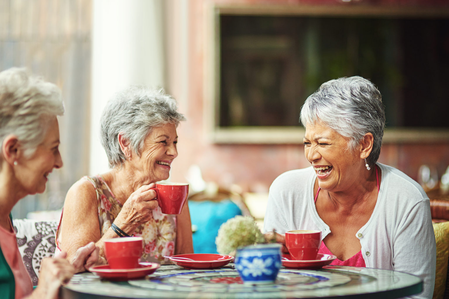 Shot of a group of elderly friends having coffee together