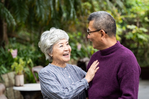Smiling happy Asian Senior Couple in the park