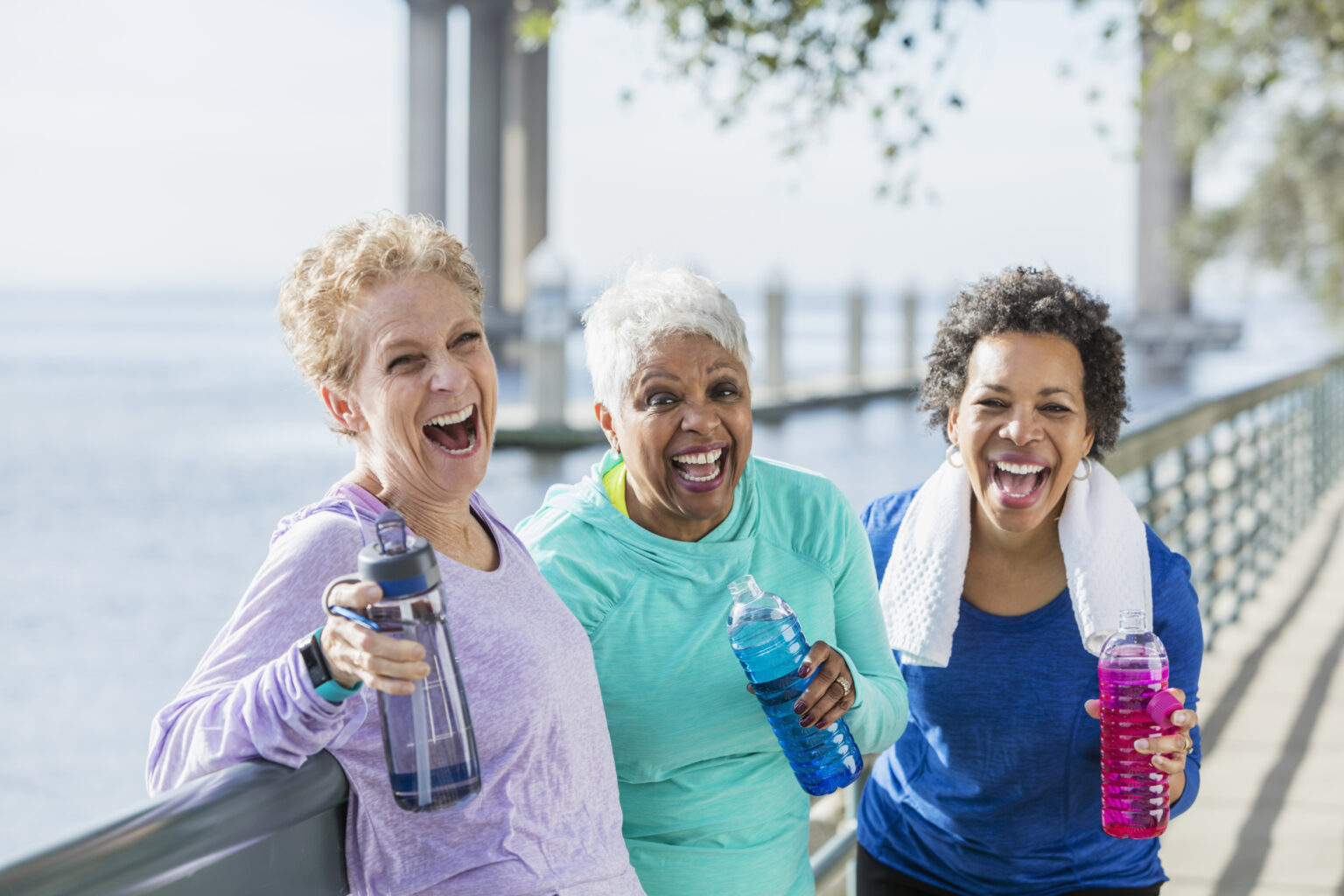 Three mature and senior women exercising on waterfront