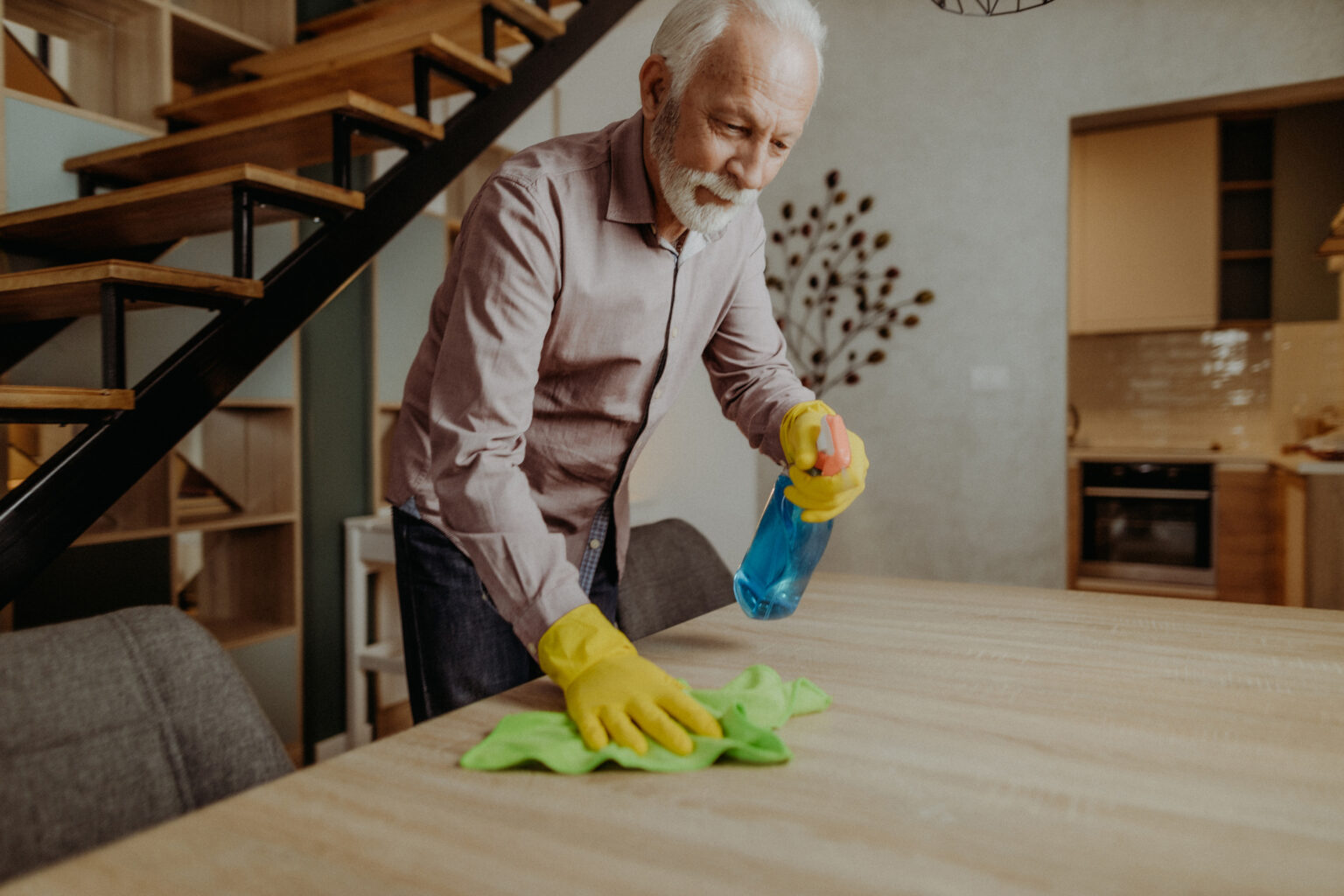 Senior man cleaning his home